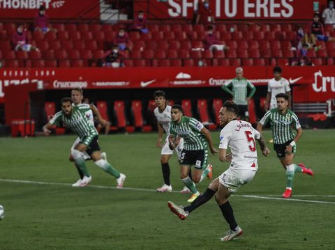 Sevilla and Betis players during their Spanish La Liga soccer match in Seville, Spain, Thursday, June 11, 2020. With virtual crowds, daily matches and lots of testing for the coronavirus, soccer is coming back to Spain. The Spanish league resumes this week more than three months after it was suspended because of the pandemic, becoming the second top league to restart in Europe. The Bundesliga was first. The Premier League and the Italian league should be next in the coming weeks. (AP Photo)