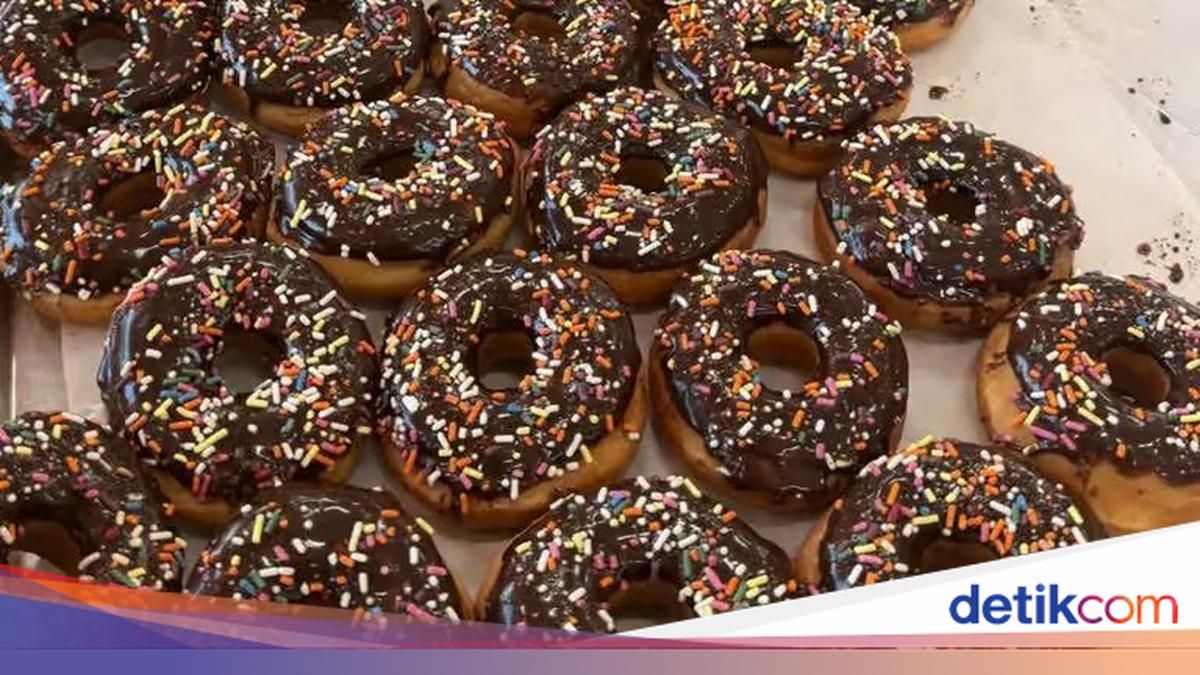 Ilustrasi donat Dunkin' berlapis cokelat dengan taburan meses
