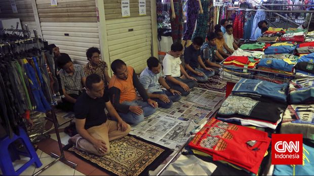 Sejumlah umat muslim melaksanakan Shalat Jumat berjamaah di antara kios-kios dagangan di Pasar Tanah bang Blok A dan B, Jakarta, Jumat, 19 Juni 2015. Meski masjid yang tersedia tidak dapat menampung, sejumlah  jamaah tetap melaksanakan ibadah di lorong tempat berjualan. CNN Indonesia/Adhi Wicaksono.