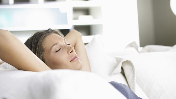 Young beautiful woman sleeping on white couch
