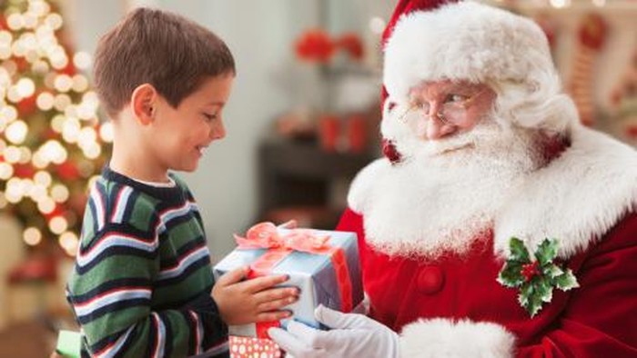 Santa giving Caucasian boy Christmas gift