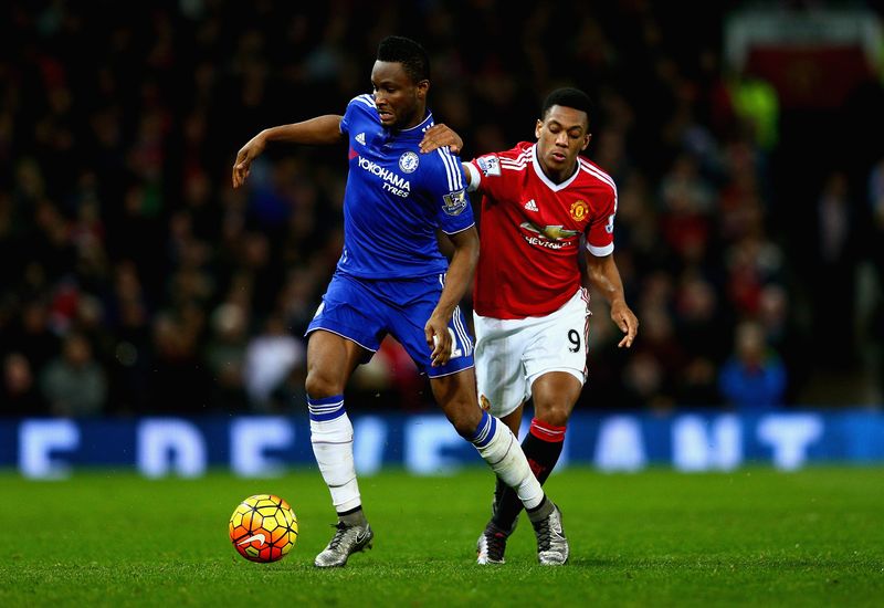   John Obi Mikel of Chelsea holds off a challenge from Anthony Martial of Manchester United during the Barclays Premier League match between Manchester United and Chelsea at Old Trafford on December 28, 2015 in Manchester, England.  (Photo by Clive Mason/Getty Images)