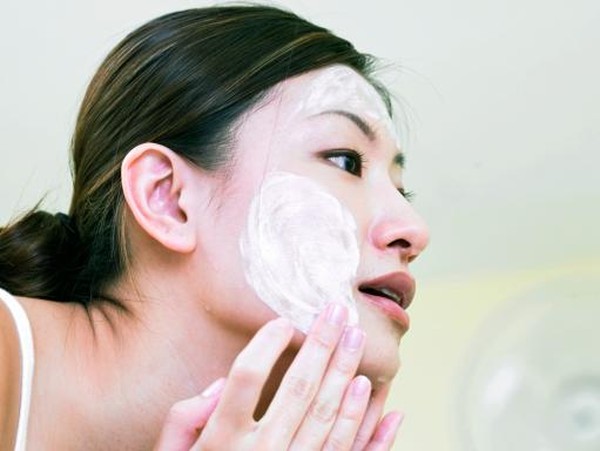 Young woman washing her face