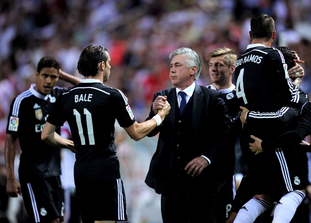 SEVILLE, SPAIN - MAY 02:  Head coach Carlo Ancelott of Real Madrid celebrates with Gareth Bale after Cristiano Ronaldo scored his team's 3rd goal during the La Liga match between Sevilla FC and Real Madrid CF at Estadio Ramon Sanchez Pizjuan on May 2, 2015 in Seville, Spain.  (Photo by Denis Doyle/Getty Images)