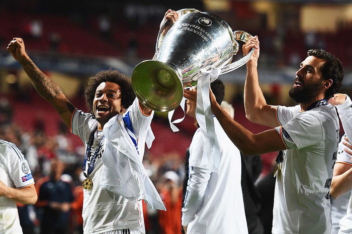 LISBON, PORTUGAL - MAY 24:  Marcelo (L) and Alvaro Arbeloa of Real Madrid celebrates victory with the trophy after the UEFA Champions League Final between Real Madrid and Atletico de Madrid at Estadio da Luz on May 24, 2014 in Lisbon, Portugal.  (Photo by Laurence Griffiths/Getty Images)
