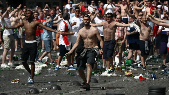 MARSEILLE, FRANCE - JUNE 11:  England fans throw bottles and clash with police ahead of the game against Russia later today on June 11, 2016 in Marseille, France. Football fans from around Europe have descended on France for the UEFA Euro 2016 football tournament.  (Photo by Carl Court/Getty Images)