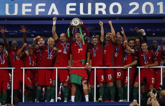 Football Soccer - Portugal v France - EURO 2016 - Final - Stade de France, Saint-Denis near Paris, France - 10/7/16
Portugals Cristiano Ronaldo celebrates with team mates and the trophy after winning Euro 2016 
REUTERS/Kai Pfaffenbach
Livepic