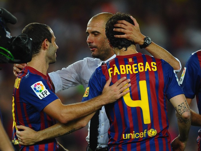 BARCELONA, SPAIN - AUGUST 17: Josep Guardiola  of Barcelona congratulates Cesc Fabregas and Javier Mascherano after victory in the Super Cup second leg match between Barcelona and Real Madrid at Nou Camp on August 17, 2011 in Barcelona, Spain.  (Photo by Laurence Griffiths/Getty Images)
