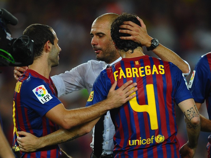 BARCELONA, SPAIN - AUGUST 17: Josep Guardiola  of Barcelona congratulates Cesc Fabregas and Javier Mascherano after victory in the Super Cup second leg match between Barcelona and Real Madrid at Nou Camp on August 17, 2011 in Barcelona, Spain.  (Photo by Laurence Griffiths/Getty Images)