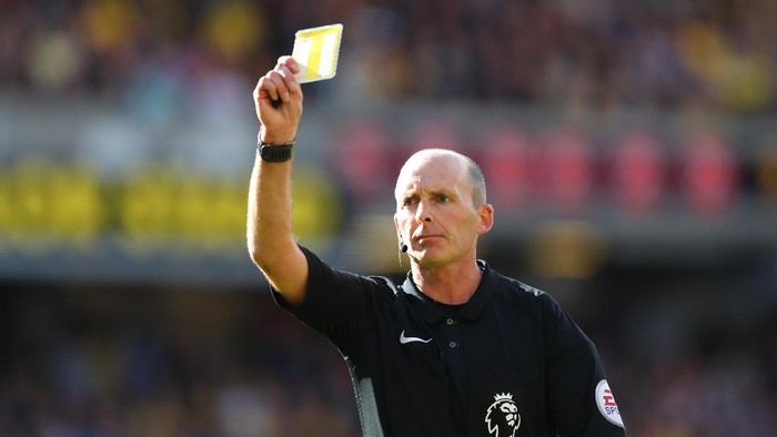 WATFORD, ENGLAND - OCTOBER 01: Mike Dean shows a yellow card to a player during the Premier League match between Watford and AFC Bournemouth at Vicarage Road on October 1, 2016 in Watford, England.  (Photo by Richard Heathcote/Getty Images)