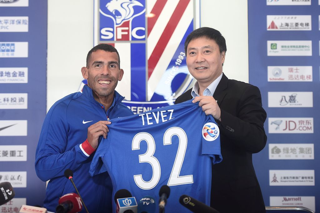 Football player Carlos Tevez holds a team shirt with Wu Xiaohui, Chairman of Shanghai Greenland Shenhua Football Club during a news conference in Shanghai, China, January 21, 2017. REUTERS/Stringer    ATTENTION EDITORS - THIS IMAGE WAS PROVIDED BY A THIRD PARTY. EDITORIAL USE ONLY. CHINA OUT. NO COMMERCIAL OR EDITORIAL SALES IN CHINA.