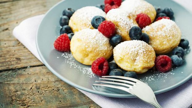 Dutch mini pancakes called poffertjes, sprinkled with powdered sugar