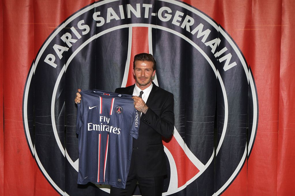PARIS, FRANCE - JANUARY 31:  International soccer player David Beckham poses with his PSG  Football shirt after his PSG signature at Parc des Princes on January 31, 2013 in Paris, France.  (Photo by Marc Piasecki/Getty Images)