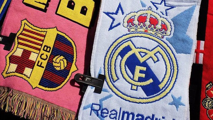 MADRID, SPAIN - DECEMBER 21: Football scarves displaying the emblems of FC Barcelona and Real Madrid are sold on a stall on December 22, 2013 in Madrid, Spain. The European Union has opened a probe into whether Real Madrid, FC Barcelona and 5 other Spanish clubs have recieved unfair preferential treatment in the past from the government and public administrations. (Photo by Denis Doyle/Getty Images)