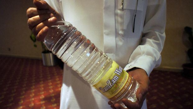 A Saudi man holds a bottle of 