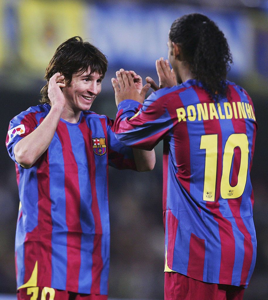 VILLARREAL, SPAIN - DECEMBER 4:  Lionel Messi (L) and Ronaldinho of Barcelona celebrate after beating Villarreal 2-0 during the Primera Liga match between Villarreal and F.C. Barcelona on December 4 2005 at the Madrigal stadium in Villarreal, Spain. (Photo by Denis Doyle/Getty Images)