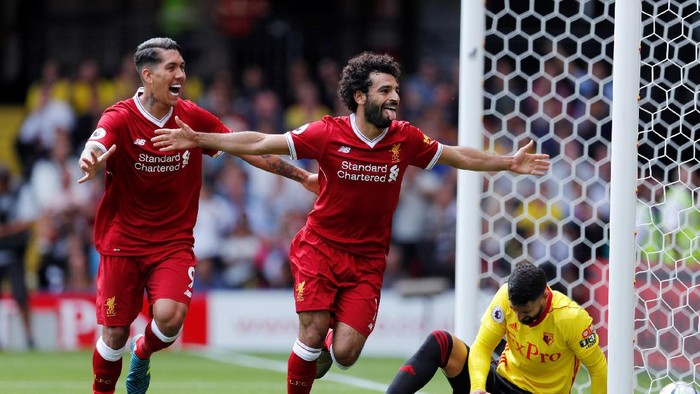 Watford vs Liverpool Football Soccer - Premier League - Watford vs Liverpool - Watford, Britain - August 12, 2017 Liverpool's Mohamed Salah celebrates scoring their third goal with Roberto Firmino as Watford's Miguel Britos looks dejected (R) Action Images via Reuters/Andrew Couldridge EDITORIAL USE ONLY. No use with unauthorized audio, video, data, fixture lists, club/league logos or