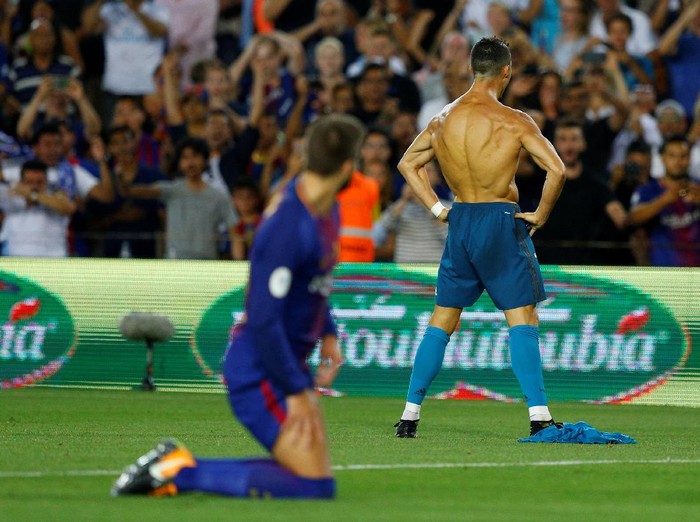 Soccer Football - Barcelona v Real Madrid Spanish Super Cup First Leg - Barcelona, Spain - August 13, 2017   Real Madrid’s Cristiano Ronaldo celebrates scoring their second goal and is later booked for removing his shirt   REUTERS/Juan Medina