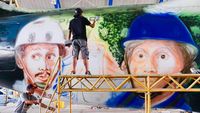 Begini Proses Mural Warkop DKI Reborn di Pesawat