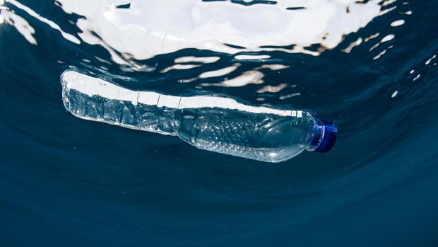 A discarded plastic bag floats at the surface of the Sea.  This image was taken to convey the concept of mans negative impact on the environment and Global Ocean pollution.  Plastic floating in the Ocean is a common sight throughout the world.  It is commonly now known as a threat to vast amounts of marine and bird life.  Its presence remains in the ocean for generations.  This image was taken whilst scuba diving in the Andaman Sea, Thailand.  I later removed the trash from the sea.