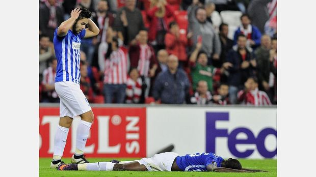 Genk's Nigerian midfielder Wilfred Ndidi (R) lies on the ground past teammate German defender Sandy Walsh during the Europa League Group F football match Athletic Club de Bilbao vs KRC Genk at the San Mames stadium in Bilbao on November 3, 2016. / AFP PHOTO / ANDER GILLENEA