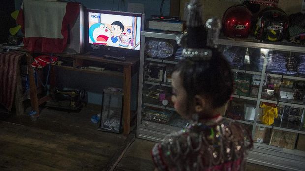 Tayangan kartun Doraemon dalam televisi yang terletak di ruang tengah di Desa Pajam, Kaledupa, Wakatobi, Sulawesi Tenggara, Minggu (17/9). ANTARA FOTO/Rosa Panggabean/17.