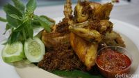 Ayam goreng bumbu kuning yang disajikan dengan lalapan dan sambal dari Redjeki Kuliner.