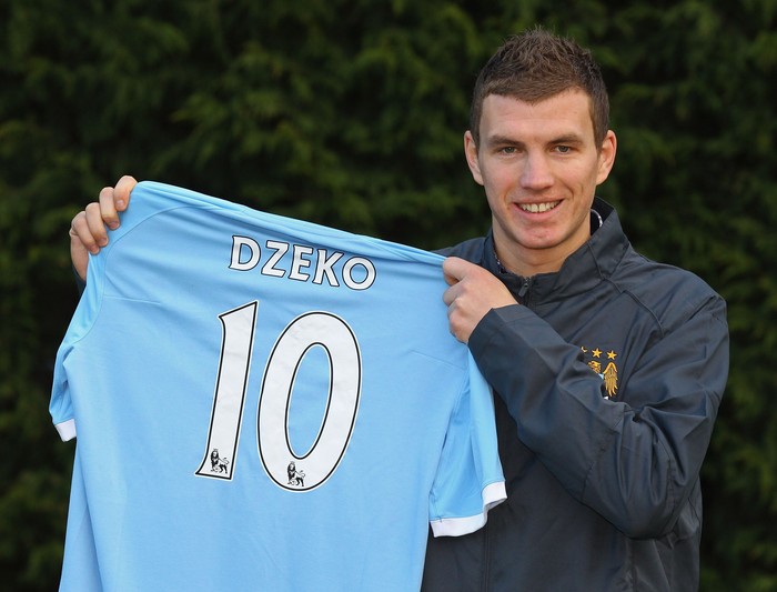 MANCHESTER, ENGLAND - JANUARY 11:  Edin Dzeko the new signing for Manchester City poses with his new shirt during a photocall at the Carrington Training Complex on January 11, 2011 in Manchester, England.  (Photo by Alex Livesey/Getty Images)