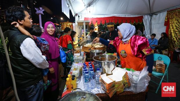 SAMBUT TAHUN BARU 2018 Warga mengunjungi stan penjualan makanan yang berada di sepanjang saat pergantian Tahun Baru 2018 di kawasan MH Thamrin, Jakarta, Minggu, 31 Desember 2017. CNNIndonesia/Safir Makki