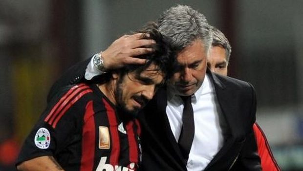 AC MIlan's midfielder Gennaro Gattuso (L) leaves the pitch flanked by AC Milan's coach Carlo Ancelotti during their   