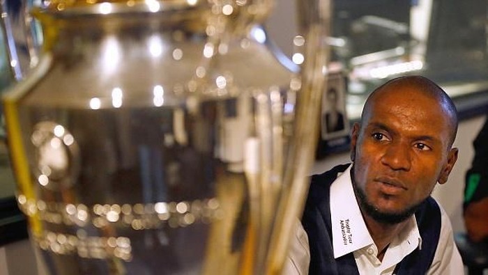 DALLAS, TX - APRIL 17:  Former French professional footballer Eric Abidal looks at the Champions League Trophy during an interview with KTCK 1310 The Ticket radio station to promote the 2015 UEFA Champions League Trophy Tour presented by Heineken on April 17, 2015 in Dallas, Texas.  (Photo by Mike Stone/Getty Images)