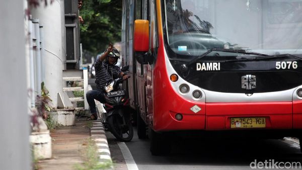 Foto: Hindari Polisi, Pemotor Terjepit Bus TransJ