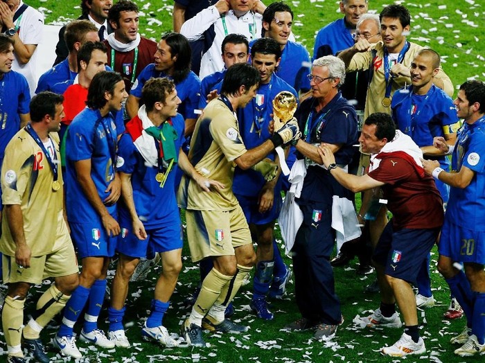 BERLIN - JULY 09: Marcello Lippi the coach of Italy and Goalkeeper Gianluigi Buffon hold the World Cup trophy  following their teams victory in a penalty shootout at the end of the FIFA World Cup Germany 2006 Final match between Italy and France at the Olympic Stadium on July 9, 2006 in Berlin, Germany.  (Photo by Clive Mason/Getty Images)
