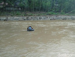 Waswas Lihat Bocah SD Ini Seberangi Sungai Pakai Ban