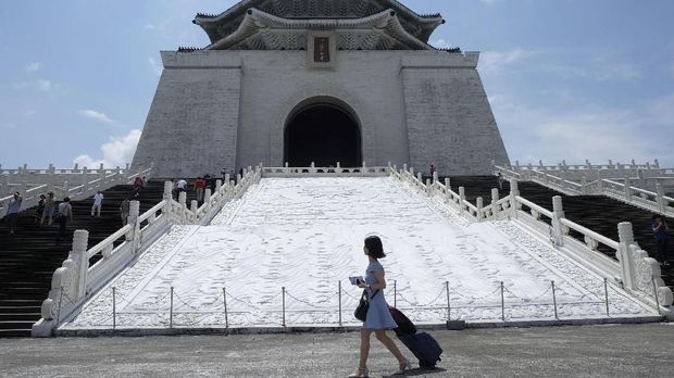 A tourist walks past the Chiang Kai-skek Memorial Hall in Taipei on May 18, 2017. AFP PHOTO / SAM YEH