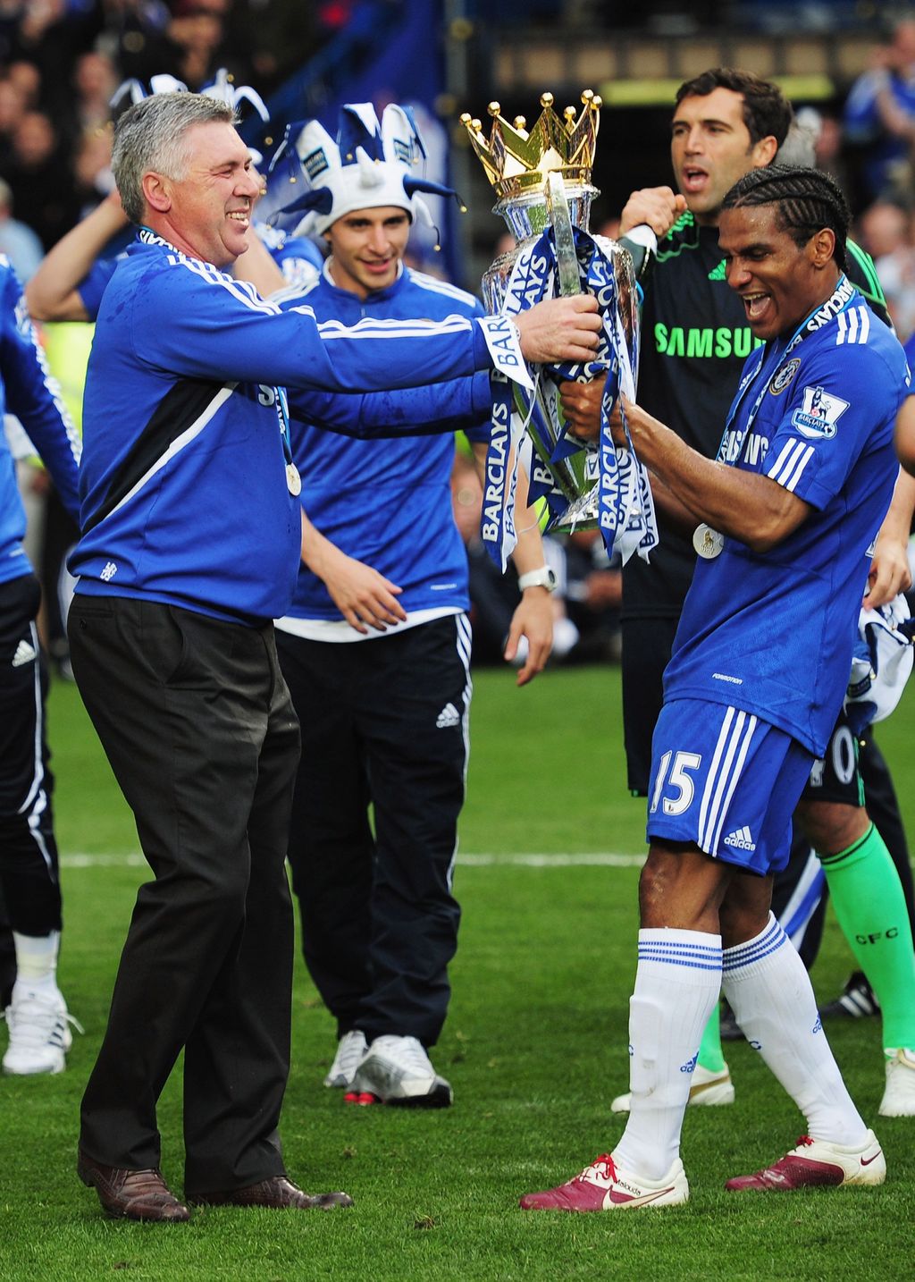 LONDON, ENGLAND - MAY 09:  Manager Carlo Ancelotti and Florent Malouda of Chelsea celebrate with the trophy after the Barclays Premier League match between Chelsea and Wigan Athletic at Stamford Bridge on May 9, 2010 in London, England. Chelsea won 8-0 to win the title.  (Photo by Shaun Botterill/Getty Images)