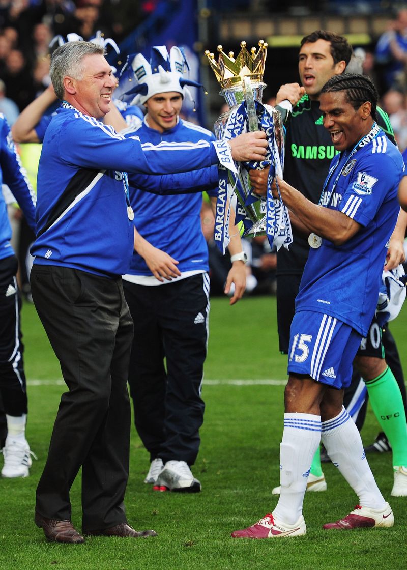 LONDON, ENGLAND - MAY 09:  Manager Carlo Ancelotti and Florent Malouda of Chelsea celebrate with the trophy after the Barclays Premier League match between Chelsea and Wigan Athletic at Stamford Bridge on May 9, 2010 in London, England. Chelsea won 8-0 to win the title.  (Photo by Shaun Botterill/Getty Images)