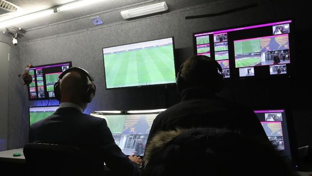 (FILES) In this file photo taken on October 25, 2017 Brazilian referee Wilton Pereira Sampaio (C) and his assistants pass by a screen of the Video Assistant Referee (VAR) before the start of the Copa Libertadores 2017 semifinal first leg football match between Argentina's River Plate and Lanus at the Monumental stadium in Buenos Aires.The controversial Video Assistant Referee (VAR) system looks set to be used at the World Cup in Russia after international rules body IFAB gave it their backing on March 3, 2018.