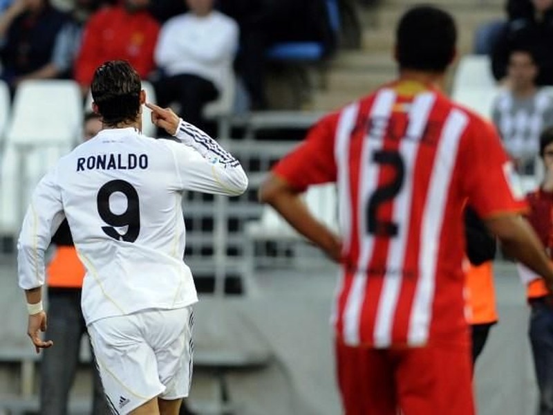 Real Madrid's Portuguese forward Cristiano Ronaldo (L) celebrates after scoring against Almeria during a Spanish league football match at Juegos Mediterraneos stadium in Almeria, on April 15, 2010. AFP PHOTO / CRISTINA QUICLER / AFP PHOTO / CRISTINA QUICLER