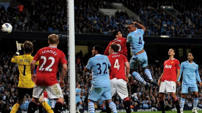 MANCHESTER, ENGLAND - APRIL 30: Vincent Kompany of Manchester City scores the opening goal during the Barclays Premier League match between Manchester City and Manchester United at the Etihad Stadium on April 30, 2012 in Manchester, England. (Photo by Michael Regan/Getty Images)