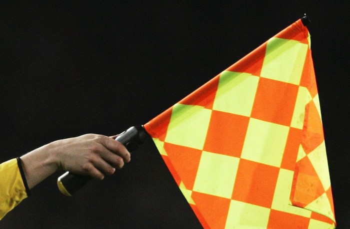 BARCELONA - FEBRUARY 23:  Assistant referee signals for offside during the UEFA Champions League first knock-out round, first leg match between Chelsea and Barcelona at Nou Camp, on 23 February 2005 in Barcelona, Spain.
