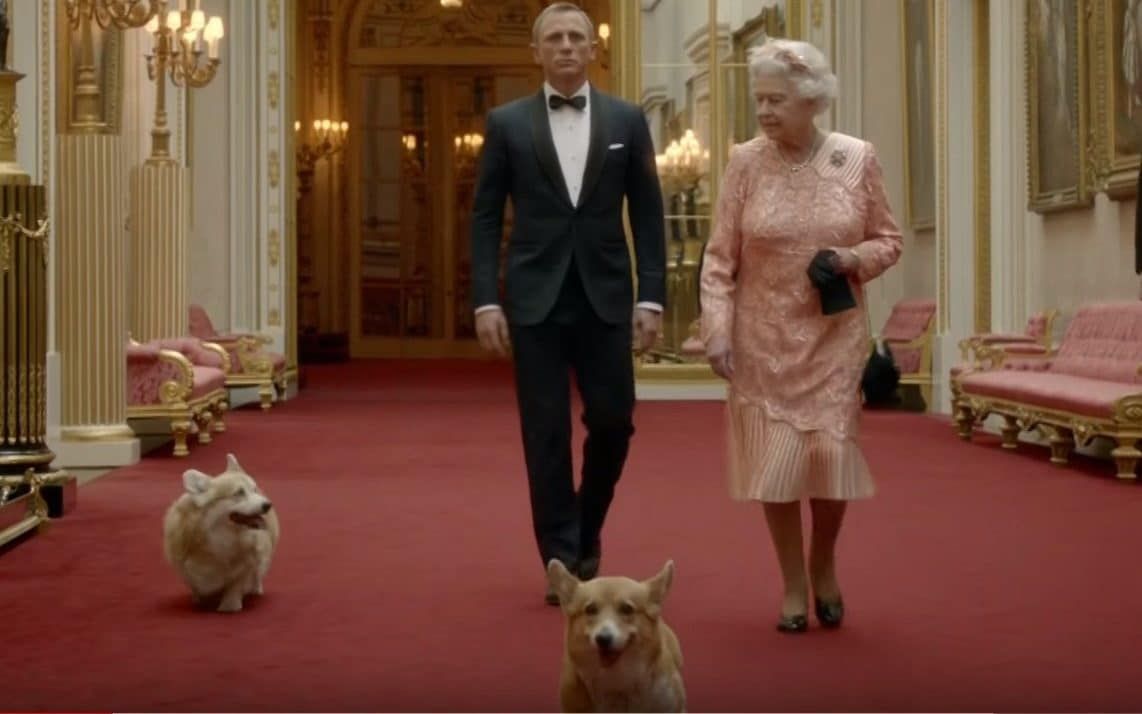 Daniel Craig and Queen Elizabeth II with her corgis Credit: Videograb