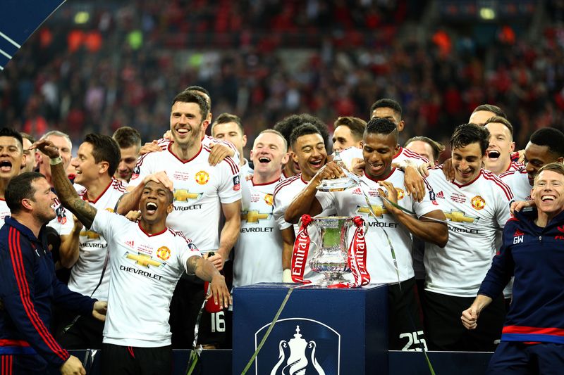 LONDON, ENGLAND - MAY 21:  Manchester United players celebrate victory with the trophy after The Emirates FA Cup Final match between Manchester United and Crystal Palace at Wembley Stadium on May 21, 2016 in London, England. Man Utd won 2-1 after extra time.  (Photo by Paul Gilham/Getty Images)