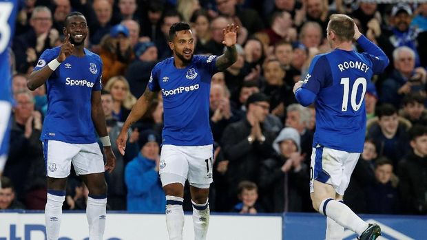 Theo Walcott (tengah) berselebrasi dengan rekan setimnya usai membobol gawang Newcastle.