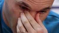 Iniesta berusaha menyeka air matanya. Foto: Albert Gea/Reuters