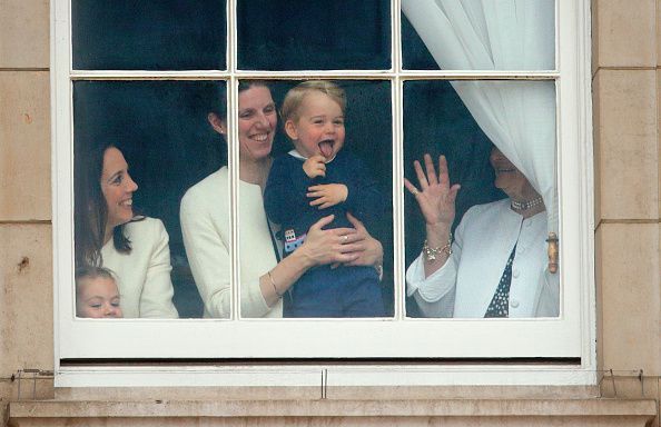 LONDON, UNITED KINGDOM - JUNE 13: (EMBARGOED FOR PUBLICATION IN UK NEWSPAPERS UNTIL 48 HOURS AFTER CREATE DATE AND TIME) Prince George of Cambridge being held up at a window of Buckingham Palace by his nanny  Maria Teresa Turrion Borrallo to watch Trooping the Colour on June 13, 2015 in London, England. The ceremony is Queen Elizabeth II's annual birthday parade and dates back to the time of Charles II in the 17th Century, when the Colours of a regiment were used as a rallying point in battle. (Photo by Max Mumby/Indigo/Getty Images)