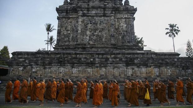 Sejumlah Bhiksu melakukan pradaksina atau mengelilingi candi membawa Api Dharma dengan obor yang diambil dari api abadi Mrapen Kabupaten Grobogan saat prosesi penyemayaman Api Dharma Waisak 2018 di Candi Mendut, Magelang, Jawa Tengah, Minggu (27/5). Penyemayaman api abadi tersebut merupakan rangkaian dari ritual menjelang hari raya Waisak 2562 BE/2018. ANTARA FOTO/Hendra Nurdiyansyah/aww/18.