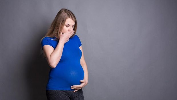 Young vomiting woman portrait. Pregnant blonde suffering with nausea. Pregnancy symptoms, gestosis, parenthood concept
