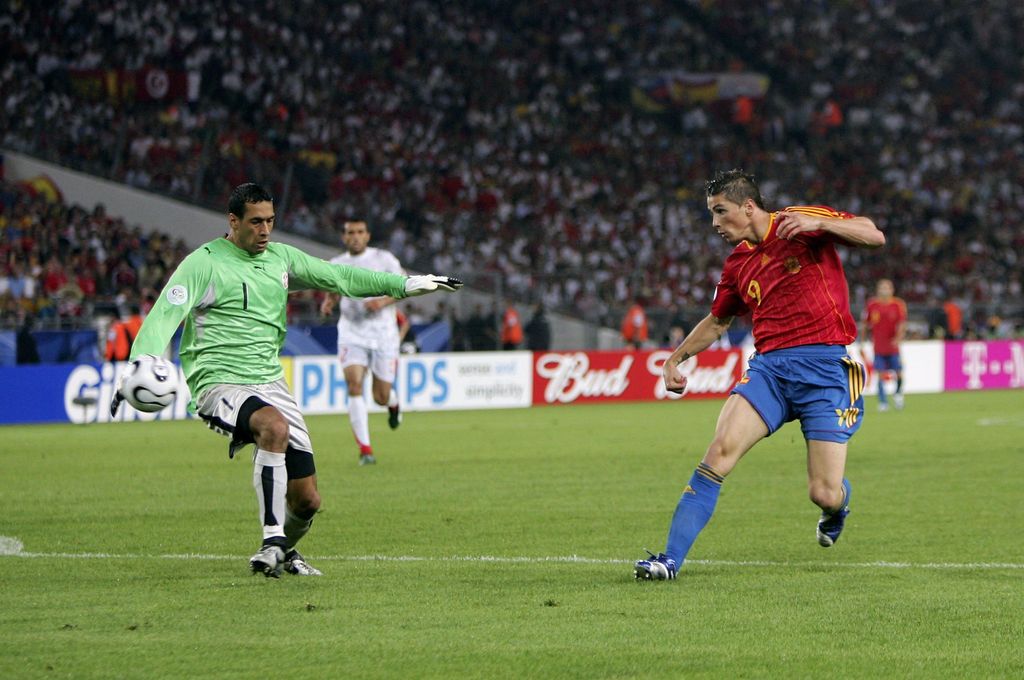 STUTTGART, GERMANY - JUNE 19:  Fernando Torres (R) of Spain, scores his team's second goal past Goalkeeper Ali Boumnijel of Tunisia during the FIFA World Cup Germany 2006 Group H match between Spain and Tunisia at the Gottlieb-Daimler Stadium on June 19, 2006 in Stuttgart, Germany.  (Photo by Michael Steele/Getty Images)