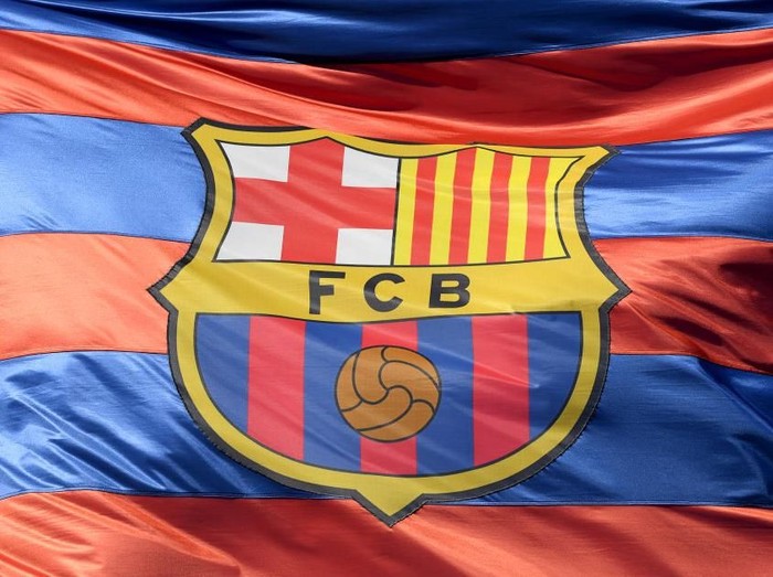BARCELONA, SPAIN - APRIL 04: The Barcelona logo is seen on a flag waving above the stadium prior to the UEFA Champions League Quarter Final Leg One match between FC Barcelona and AS Roma at Camp Nou on April 4, 2018 in Barcelona, Spain.  (Photo by Mike Hewitt/Getty Images)